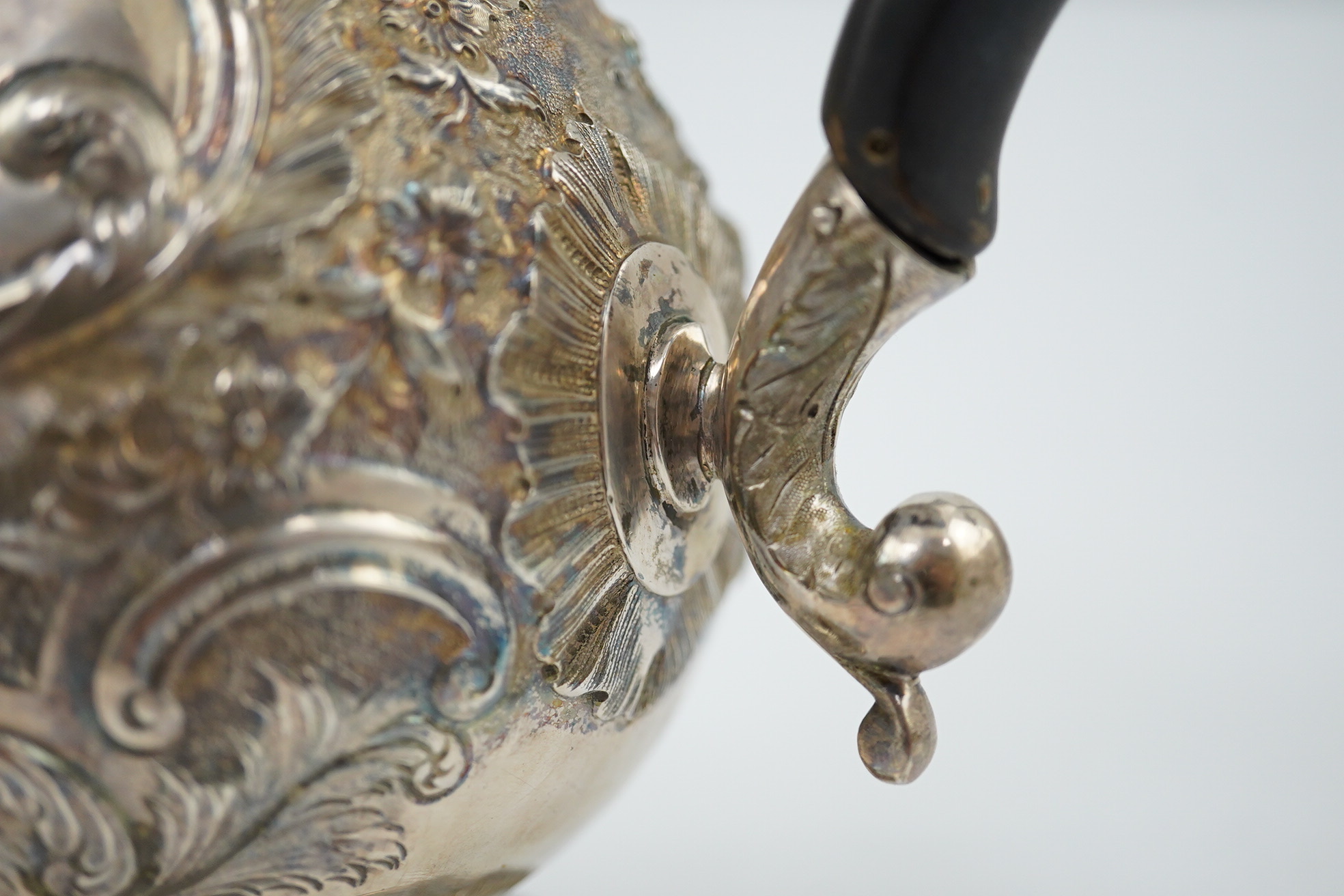 A George III silver coffee pot, by Aldridge & Green, with later embossed decoration